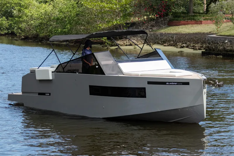 Slide: The Image of 2024 De Antonio Yachts D28 Cruiser on a serene waterway, featuring sleek modern design. - 0