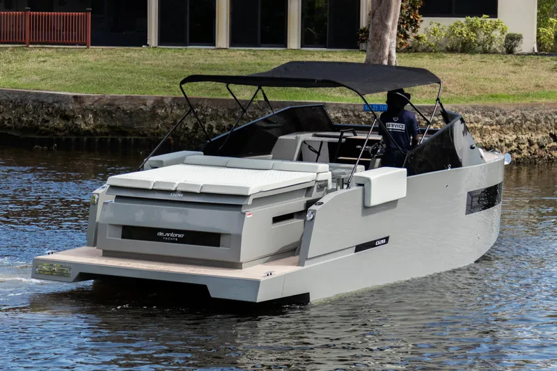 Slide: The Image of 2024 De Antonio Yachts D28 Cruiser on a calm waterway, showcasing sleek design and modern features. - 1
