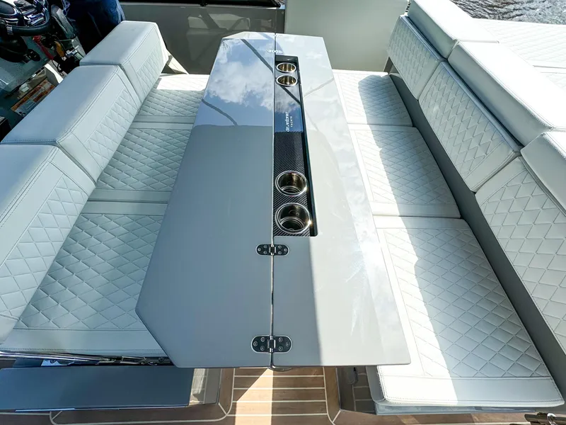 Slide: The Image of 2024 De Antonio Yachts D28 Cruiser interior with sleek seating and modern table design. - 16
