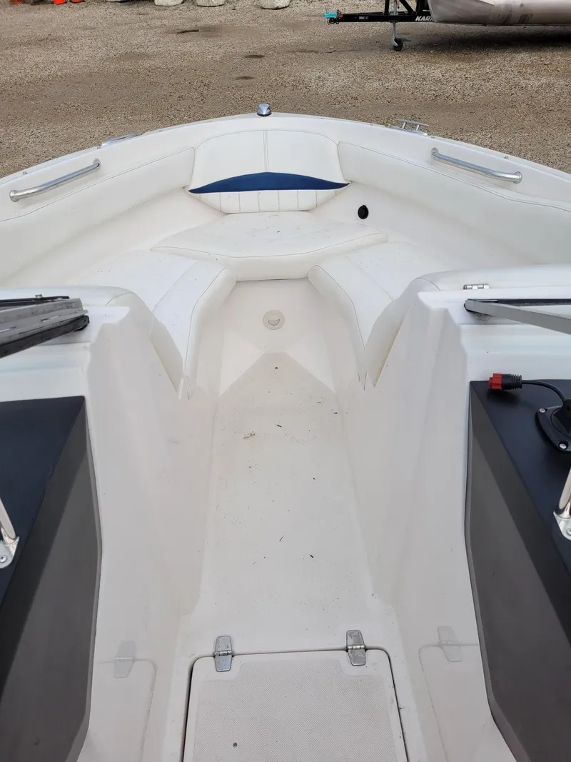 Slide: The Image of 2008 Regal ES2000 boat interior with white seating and storage compartments. - 12