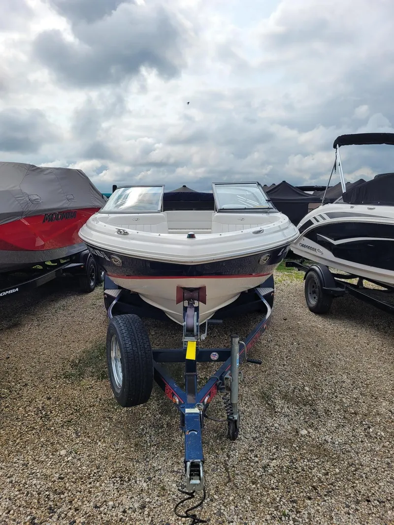 Slide: The Image of 2008 Regal ES2000 boat on trailer under cloudy sky. - 3