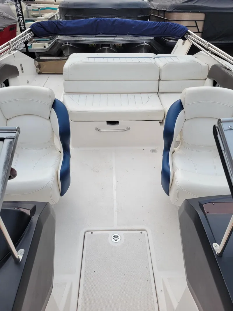 Slide: The Image of Interior of a 2008 Regal ES2000 boat with white and blue seating. - 4