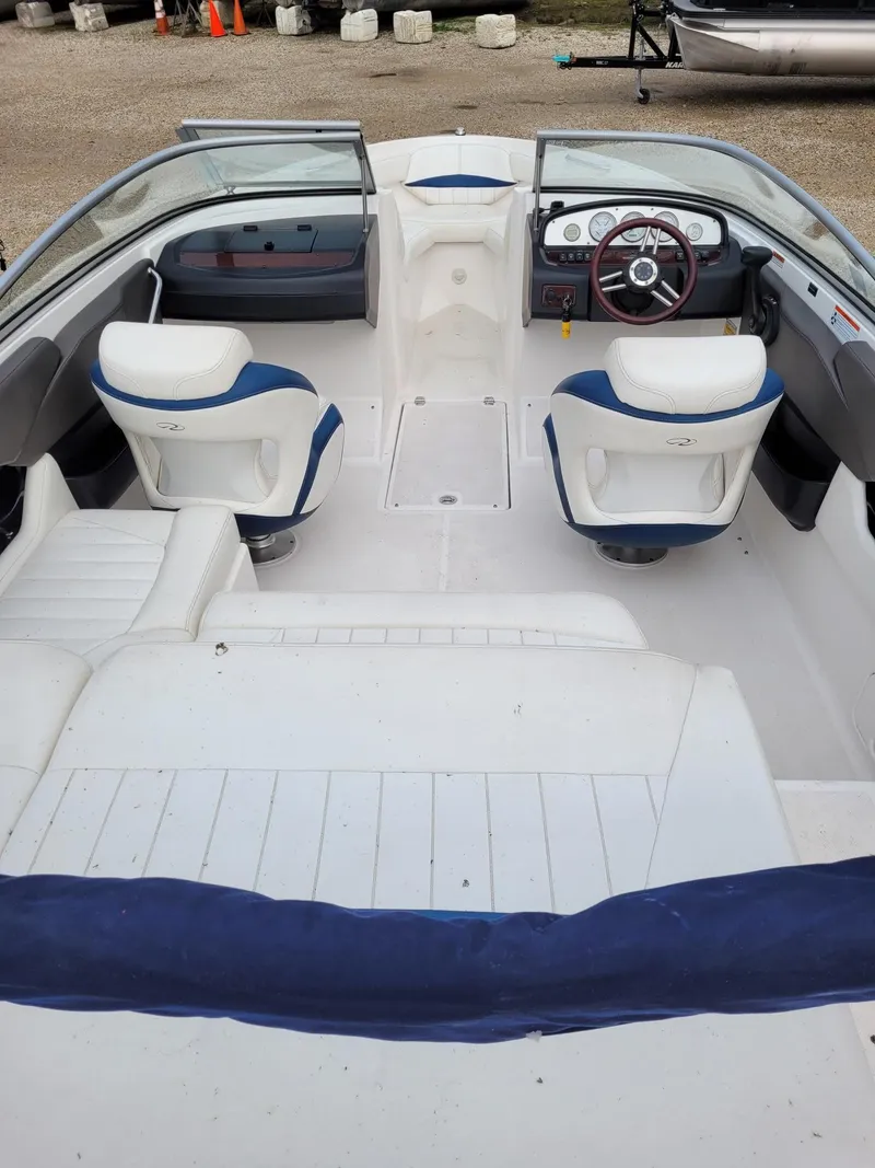 Slide: The Image of Interior of a 2008 Regal ES2000 boat with white and blue seating. - 6