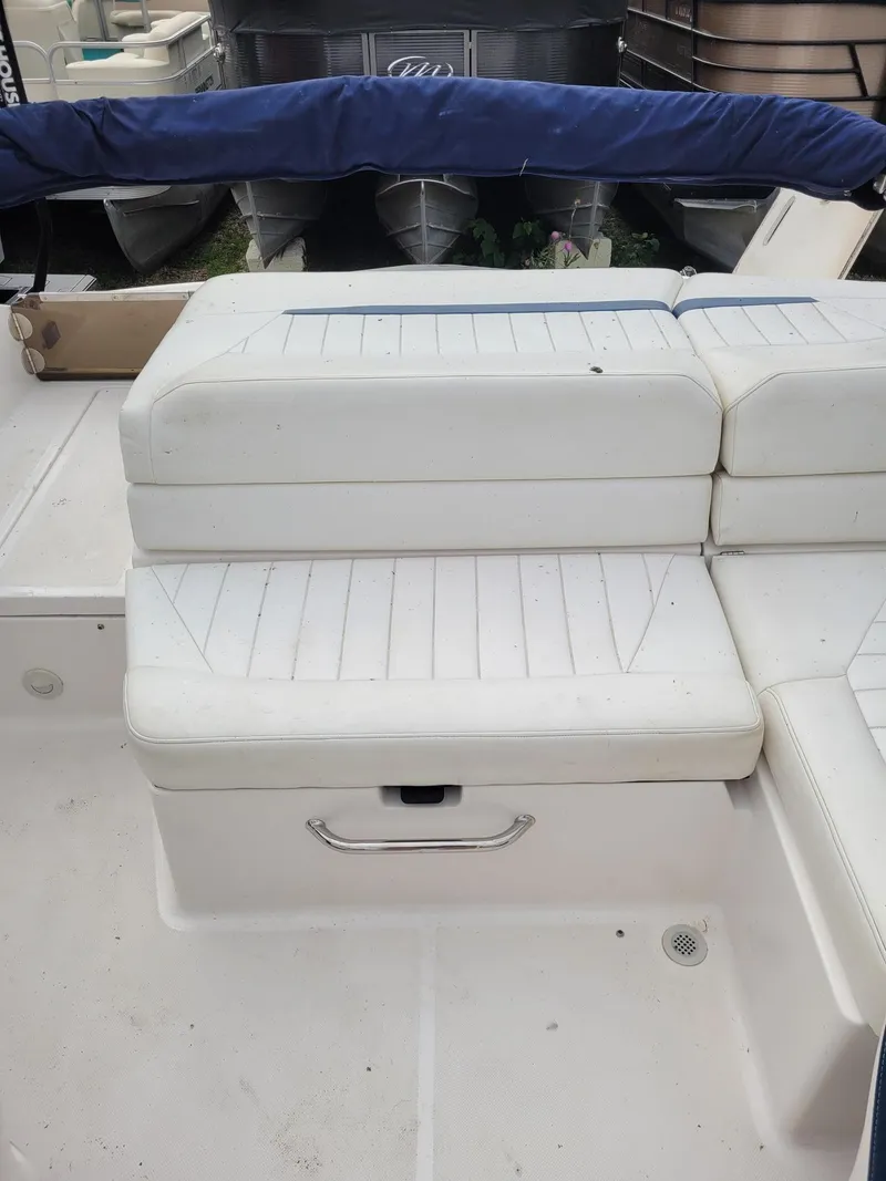 Slide: The Image of White seating on a 2008 Regal ES2000 boat, with blue cover in background. - 7