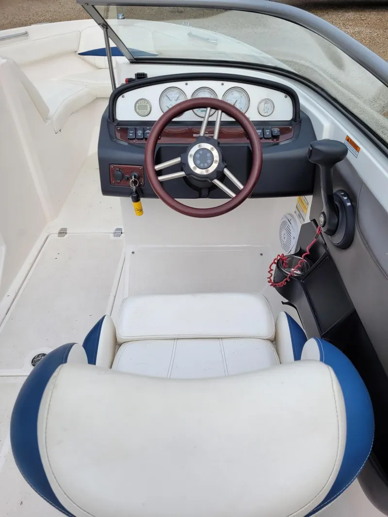 Slide: The Image of 2008 Regal ES2000 boat cockpit with steering wheel and dashboard controls. - 8