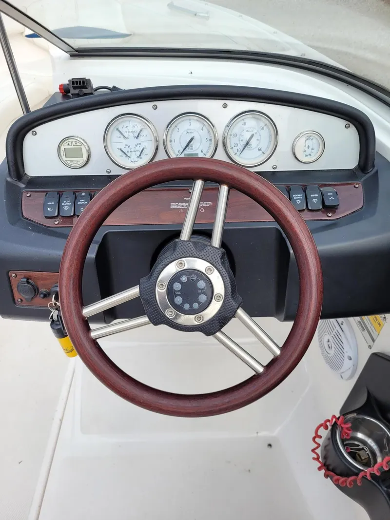 Slide: The Image of Steering wheel and dashboard of a 2008 Regal ES2000 boat. - 9