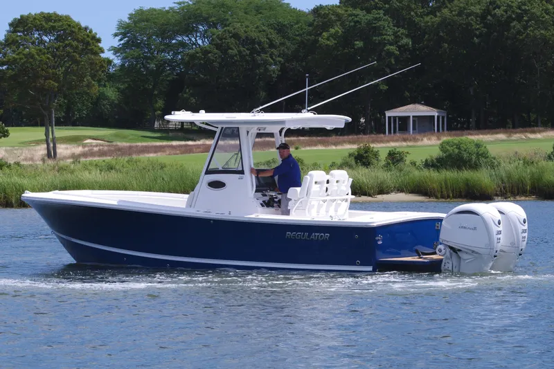 Slide: The Image of 2025 Regulator 28 boat cruising on a scenic waterway. - 3