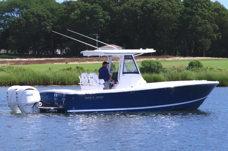 Slide: The Image of 2025 Regulator 28 boat on water, featuring sleek design and dual engines. - 7