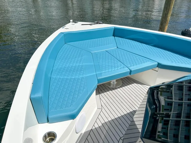Slide: The Image of 2023 De Antonio Yachts D28 Open with blue cushioned seating on deck. - 7