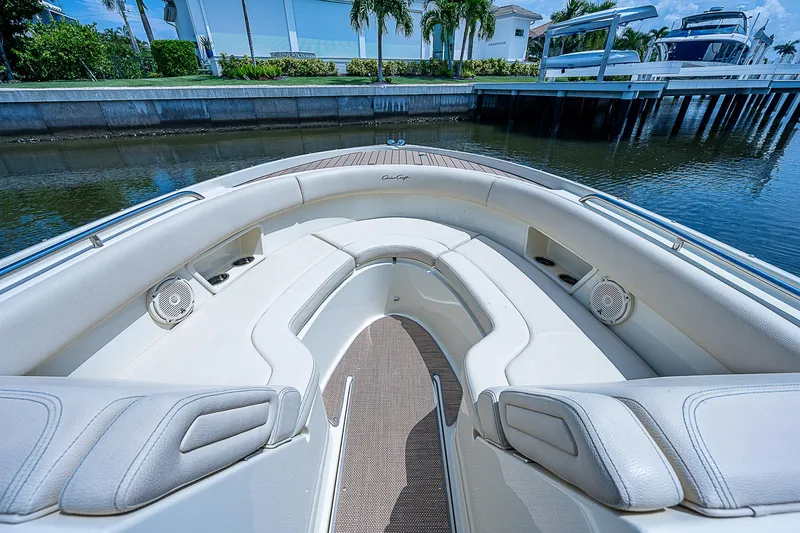 Slide: The Image of 2018 Chris-Craft Calypso 26 boat interior with plush seating and waterfront view. - 15