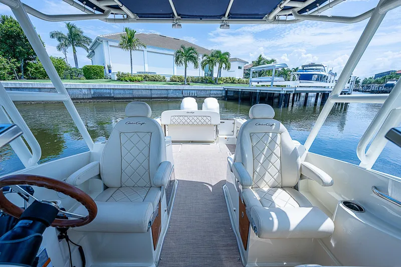 Slide: The Image of 2018 Chris-Craft Calypso 26 boat interior with luxurious seating and waterfront view. - 19