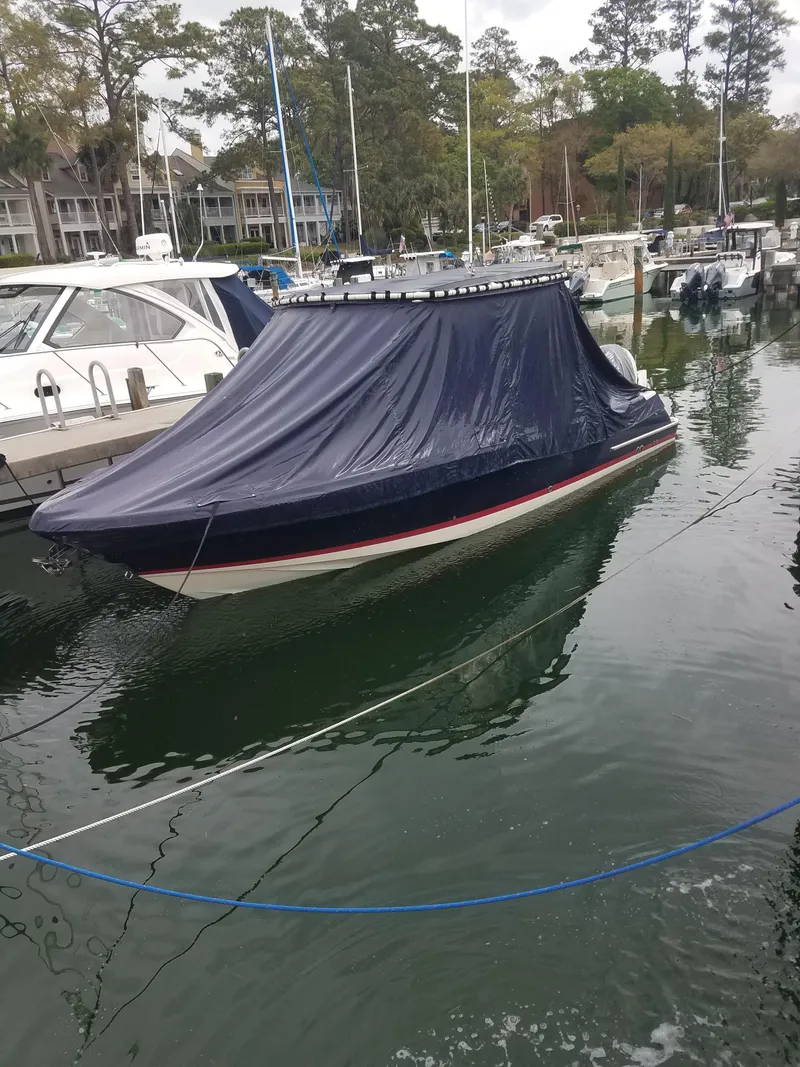 Slide: The Image of 2018 Chris-Craft Calypso 26 boat covered at marina dock. - 24