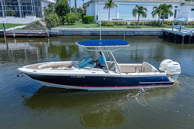 Slide: The Image of 2018 Chris-Craft Calypso 26 boat cruising on a calm canal. - 5