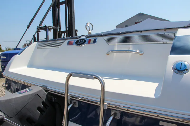 Slide: The Image of 1996 Cobalt 220 boat stern with ladder and emblem in sunlight. - 11