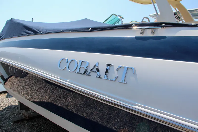 Slide: The Image of 1996 Cobalt 220 boat with blue cover and chrome logo. - 12