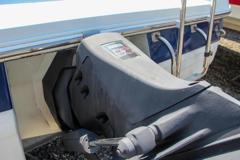 Slide: The Image of Close-up of a 1996 Cobalt 220 boat's outboard motor in a marina setting. - 13