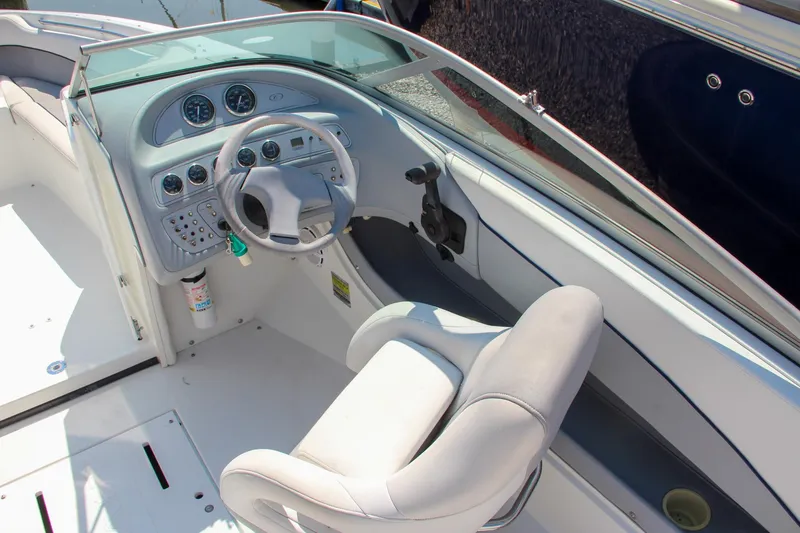 Slide: The Image of 1996 Cobalt 220 boat cockpit with steering wheel and gauges. - 16