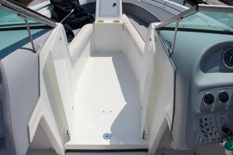 Slide: The Image of Interior of a 1996 Cobalt 220 boat, featuring white seating and control panel. - 18