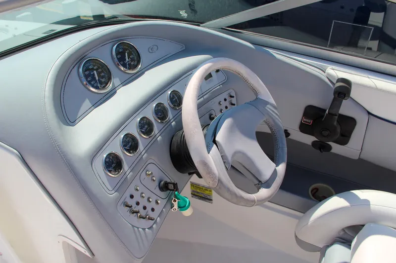 Slide: The Image of 1996 Cobalt 220 boat dashboard with steering wheel and instrument panel. - 19