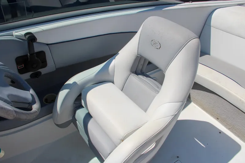 Slide: The Image of Interior of a 1996 Cobalt 220 boat featuring a white captain's chair. - 20