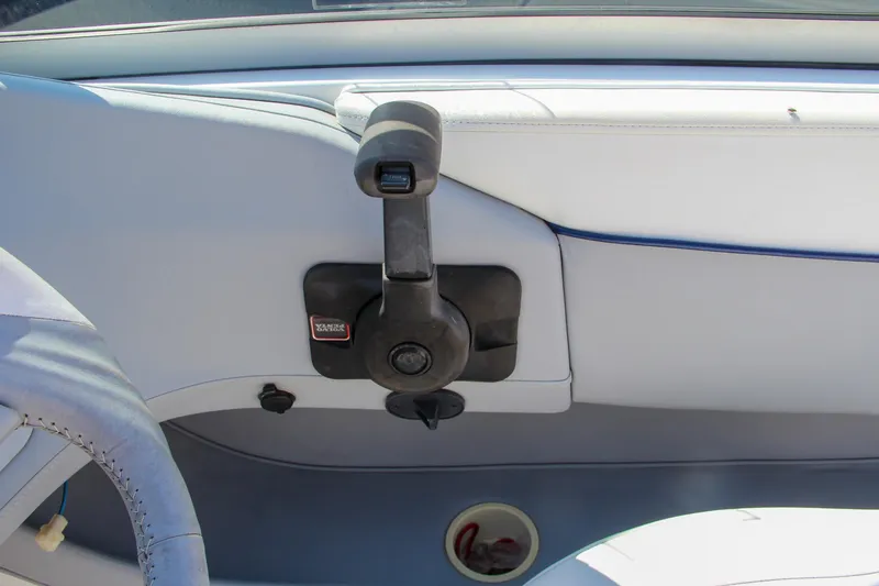 Slide: The Image of 1996 Cobalt 220 boat interior with throttle control and steering wheel. - 21