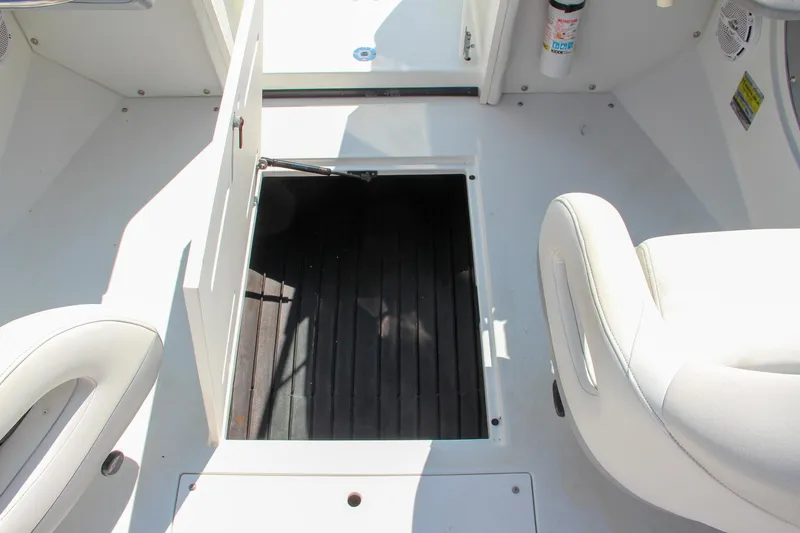 Slide: The Image of Open hatch on 1996 Cobalt 220 boat interior with white seating. - 24
