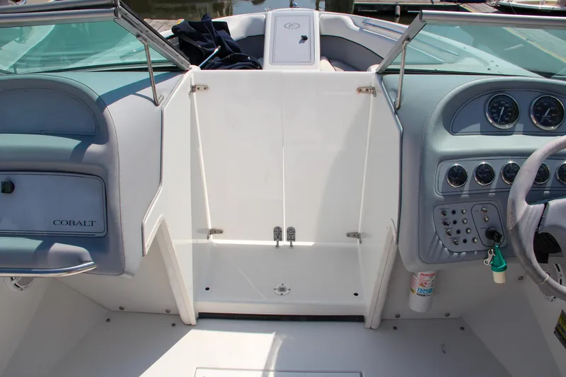 Slide: The Image of Interior of a 1996 Cobalt 220 boat, featuring dashboard and seating area. - 25