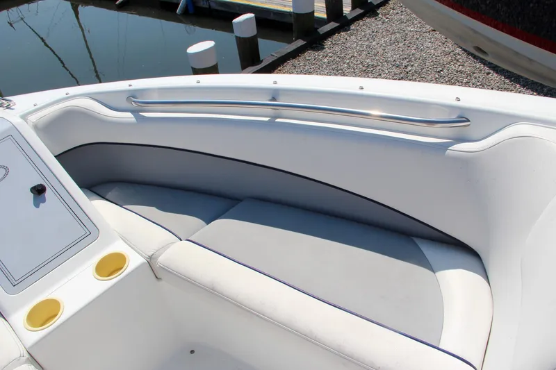 Slide: The Image of Interior of a 1996 Cobalt 220 boat with white seating and cup holders. - 27