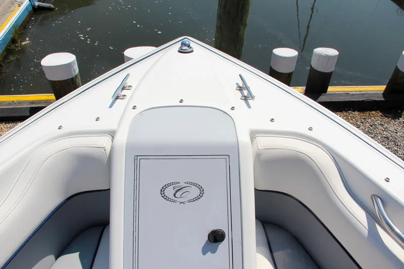 Slide: The Image of 1996 Cobalt 220 boat bow with white seating and storage compartment. - 28