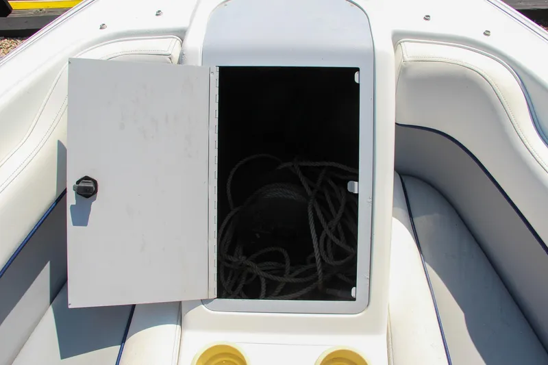 Slide: The Image of Open storage compartment on 1996 Cobalt 220 boat with coiled rope inside. - 29