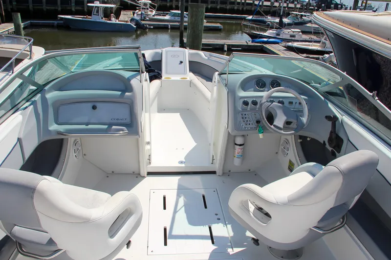 Slide: The Image of Interior of a 1996 Cobalt 220 boat with white seating and control panel. - 3