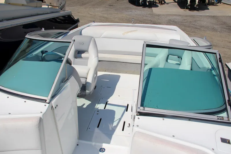 Slide: The Image of 1996 Cobalt 220 boat interior with teal accents and seating. - 30