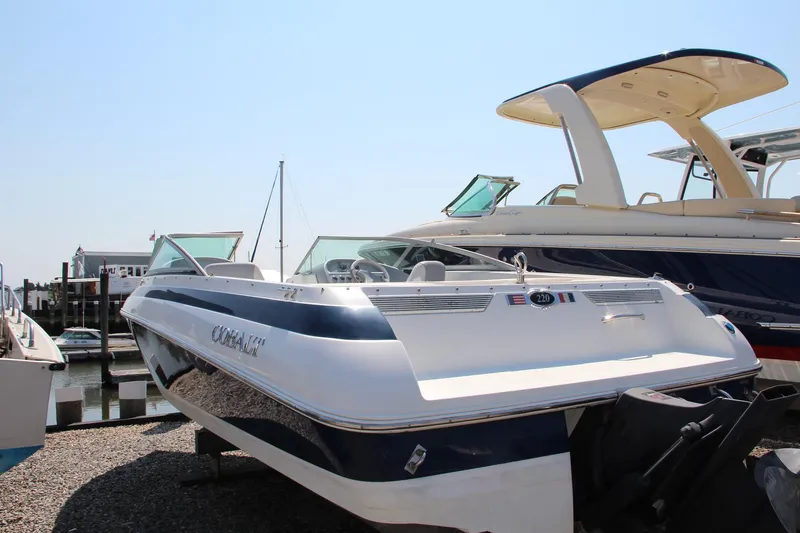 Slide: The Image of 1996 Cobalt 220 boat docked, featuring sleek design and blue accents. - 6