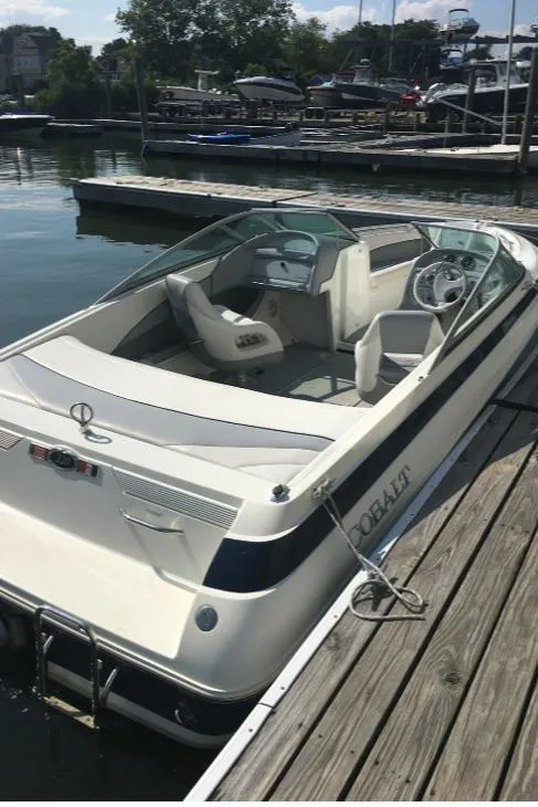 Slide: The Image of 1996 Cobalt 220 boat docked at marina, sunny day, calm water. - 7