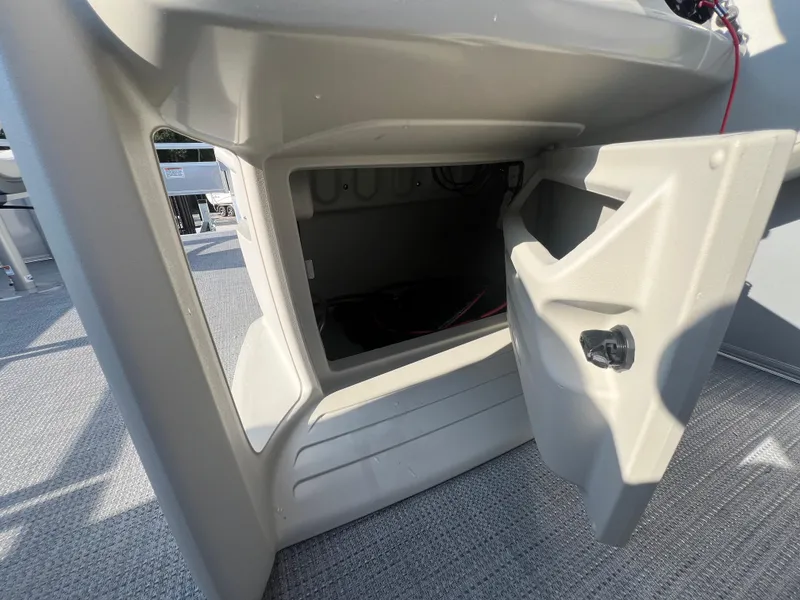 Slide: The Image of Open storage compartment on a 2025 Starcraft LX 18 F boat. - 10