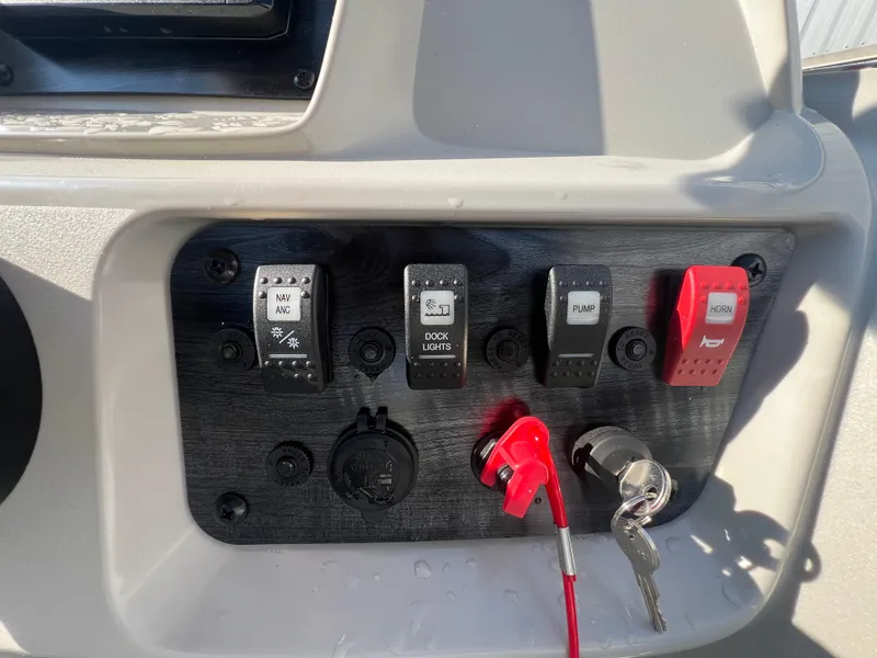 Slide: The Image of Control panel of 2025 Starcraft LX 18 F boat with switches and ignition key. - 17