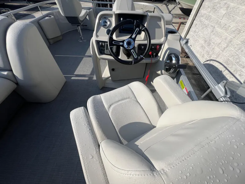 Slide: The Image of Interior of 2025 Starcraft LX 18 F boat with steering wheel and seating. - 4