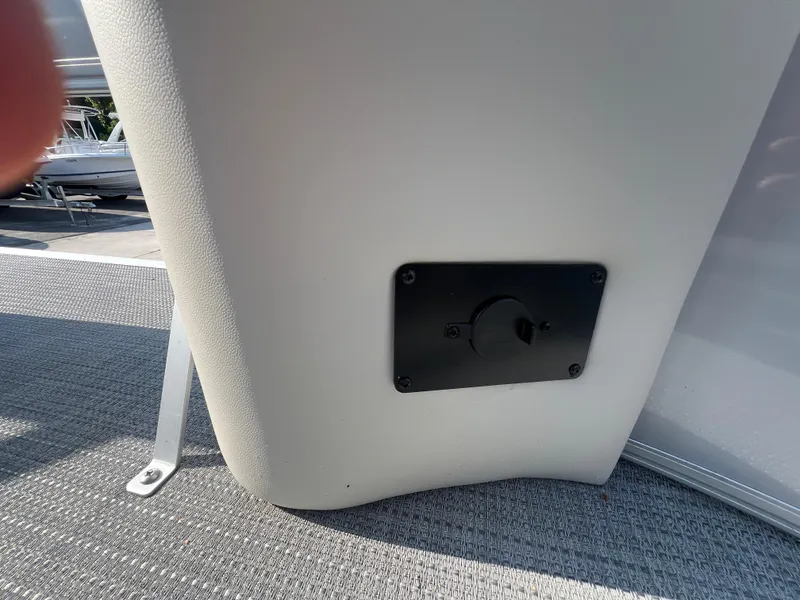 Slide: The Image of 2025 Starcraft LX 18 F boat interior detail with black panel on gray surface. - 8