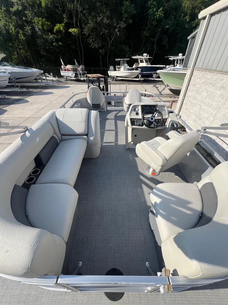 Slide: The Image of 2025 Starcraft LX 18 F pontoon boat with spacious seating and modern design. - 9