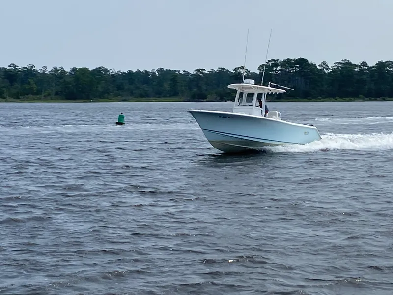 Slide: The Image of 2014 Sea Hunt Game Fish 27 boat cruising on a lake. - 10