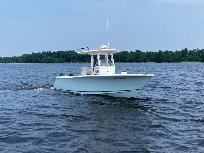 Slide: The Image of 2014 Sea Hunt Game Fish 27 boat cruising on a calm lake. - 8