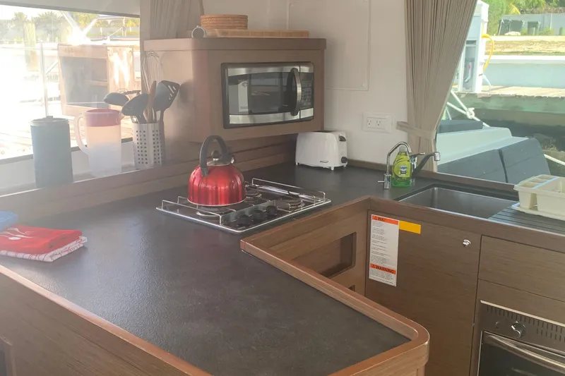 Slide: The Image of Modern kitchen in 2019 Lagoon 42 catamaran with stove, microwave, and sink. - 10