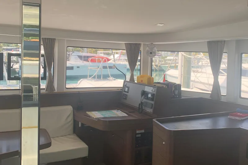 Slide: The Image of Interior of a 2019 Lagoon 42 catamaran with modern furnishings and large windows. - 12