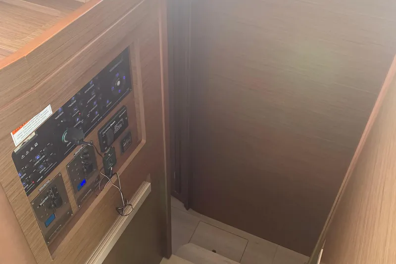 Slide: The Image of Control panel inside a 2019 Lagoon 42 yacht, featuring wooden interior design. - 14