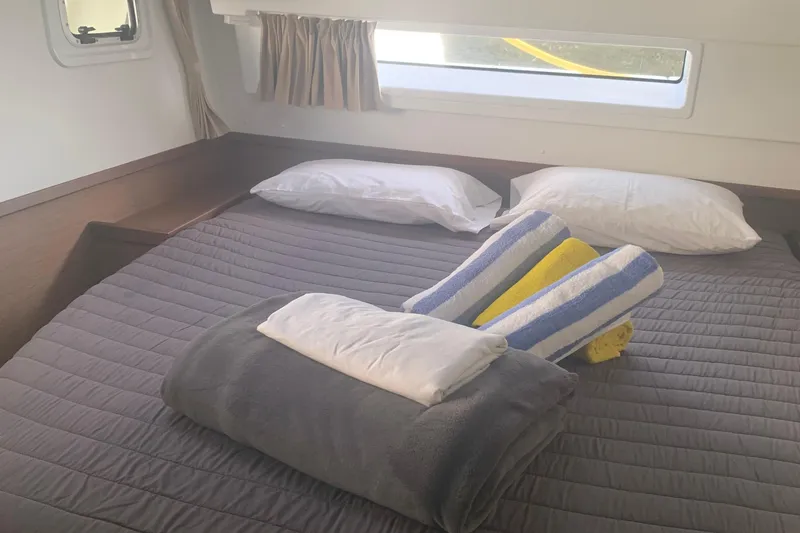 Slide: The Image of Cozy cabin interior of 2019 Lagoon 42 with neatly arranged bedding and pillows. - 20