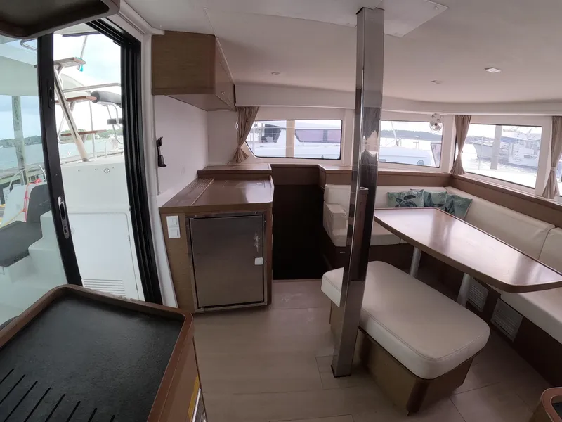 Slide: The Image of Interior of 2019 Lagoon 42 catamaran with modern seating and dining area. - 25