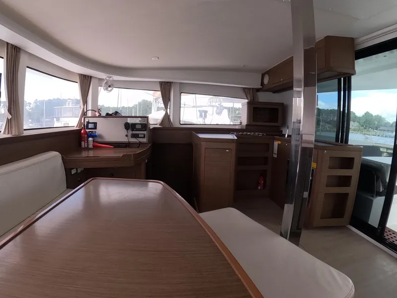 Slide: The Image of Interior of 2019 Lagoon 42 catamaran with modern kitchen and dining area. - 26