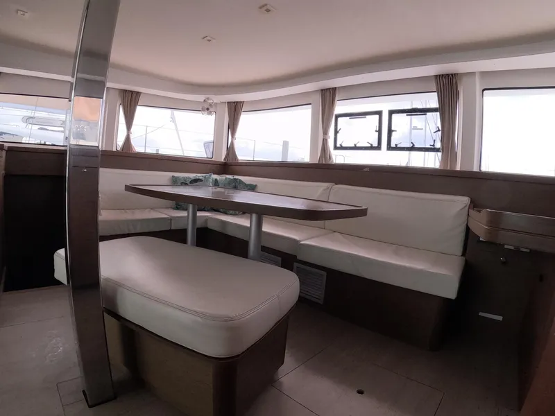 Slide: The Image of Interior of 2019 Lagoon 42 catamaran with spacious seating and large windows. - 28