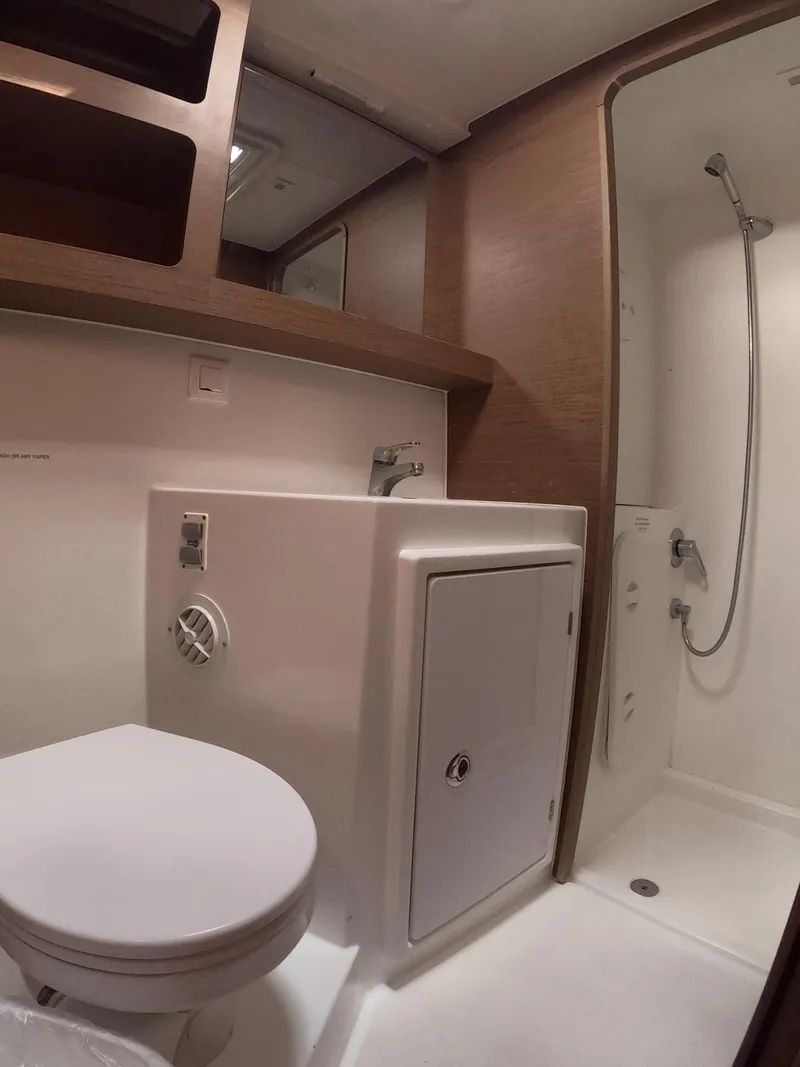 Slide: The Image of 2019 Lagoon 42 yacht bathroom with shower, sink, and toilet. - 34