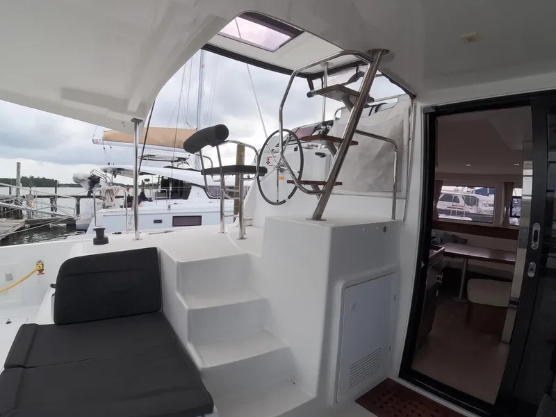 Slide: The Image of Interior view of 2019 Lagoon 42 catamaran, featuring helm station and seating area. - 37